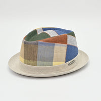 Patchwork-patterned pork pie hat on a light gray background