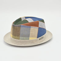 Patchwork hat with a beige base on a light gray background