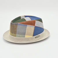 Colorful patchwork hat with a beige base on a light gray background