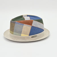 Patchwork hat with a beige base on a light gray background
