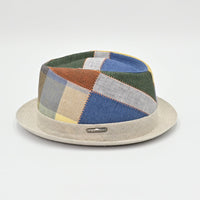 Colorful patchwork hat with a beige base on a light gray background