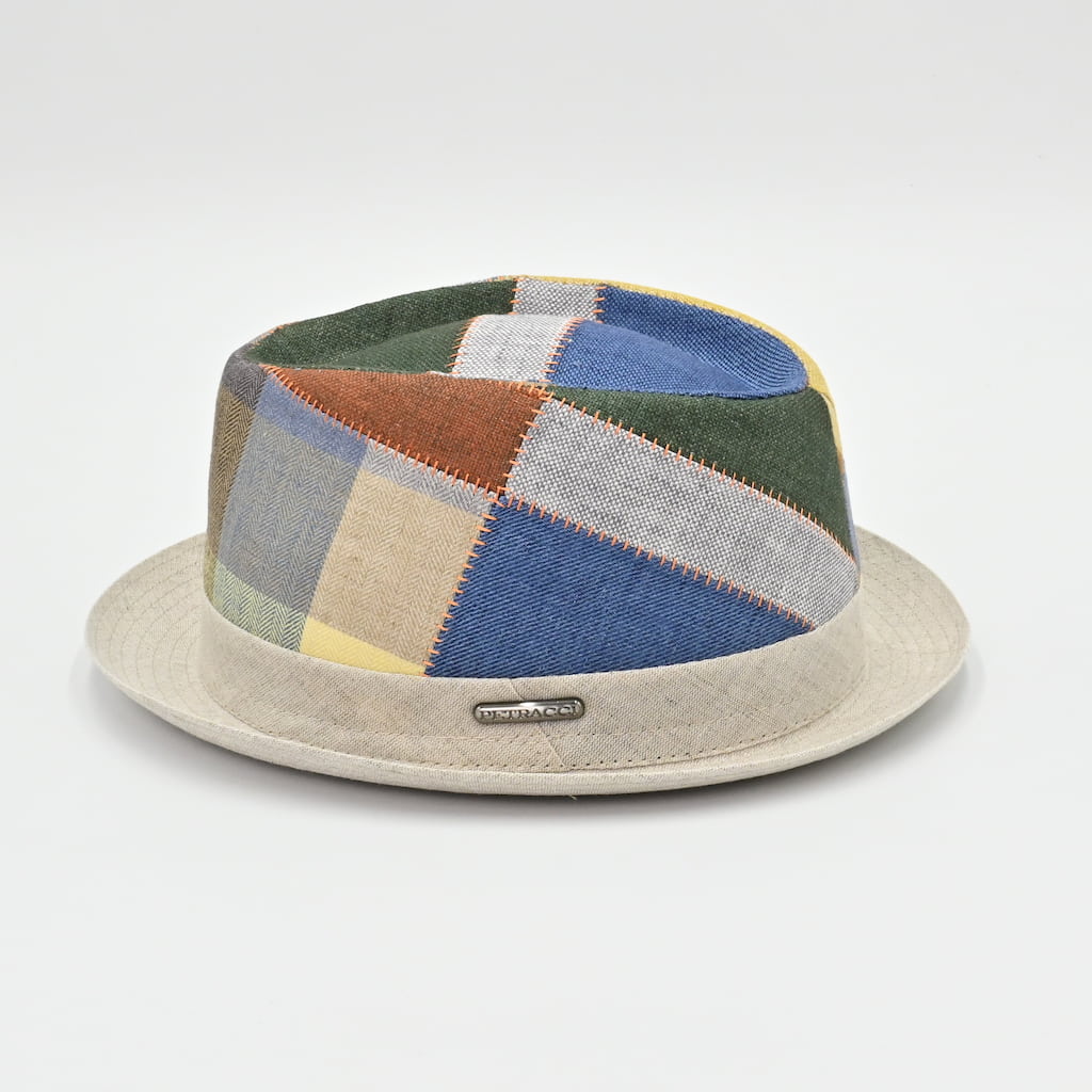 Colorful patchwork hat with a beige base on a light gray background