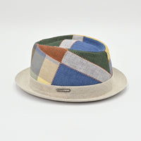 Patchwork-patterned hat with a beige base on a light gray background