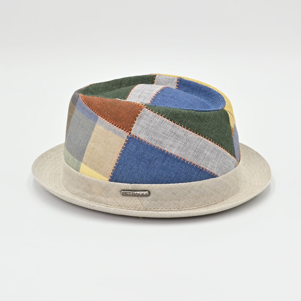 Patchwork-patterned hat with a beige base on a light gray background