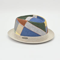 Colorful patchwork hat with a beige base on a light gray background