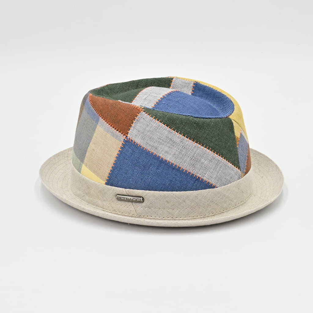 Colorful patchwork hat with a beige base on a light gray background