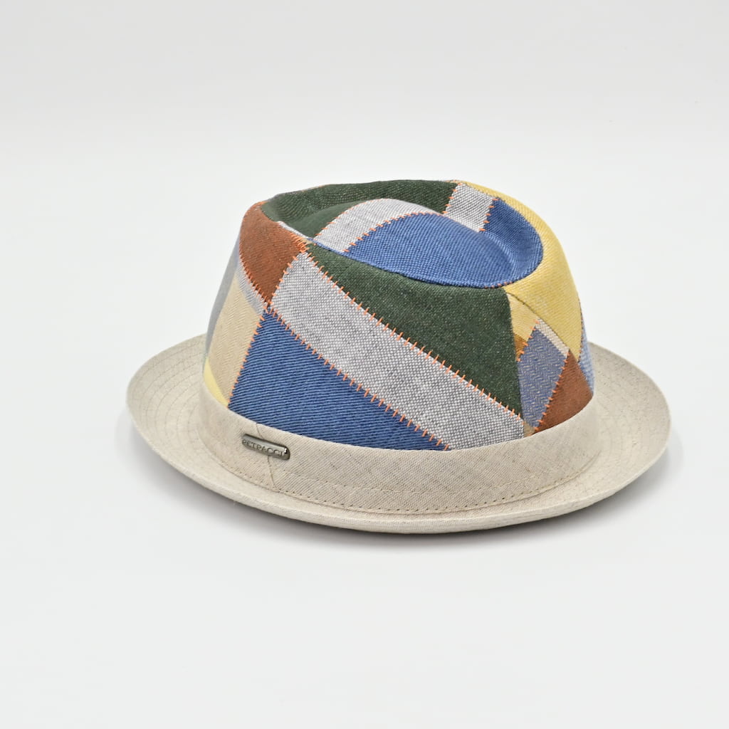 Colorful geometric-patterned pork pie hat on a light gray background