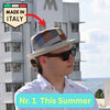 Person wearing a multicolor Italian patchwork pork pie hat and sunglasses with 'Made in Italy' label and text overlay.