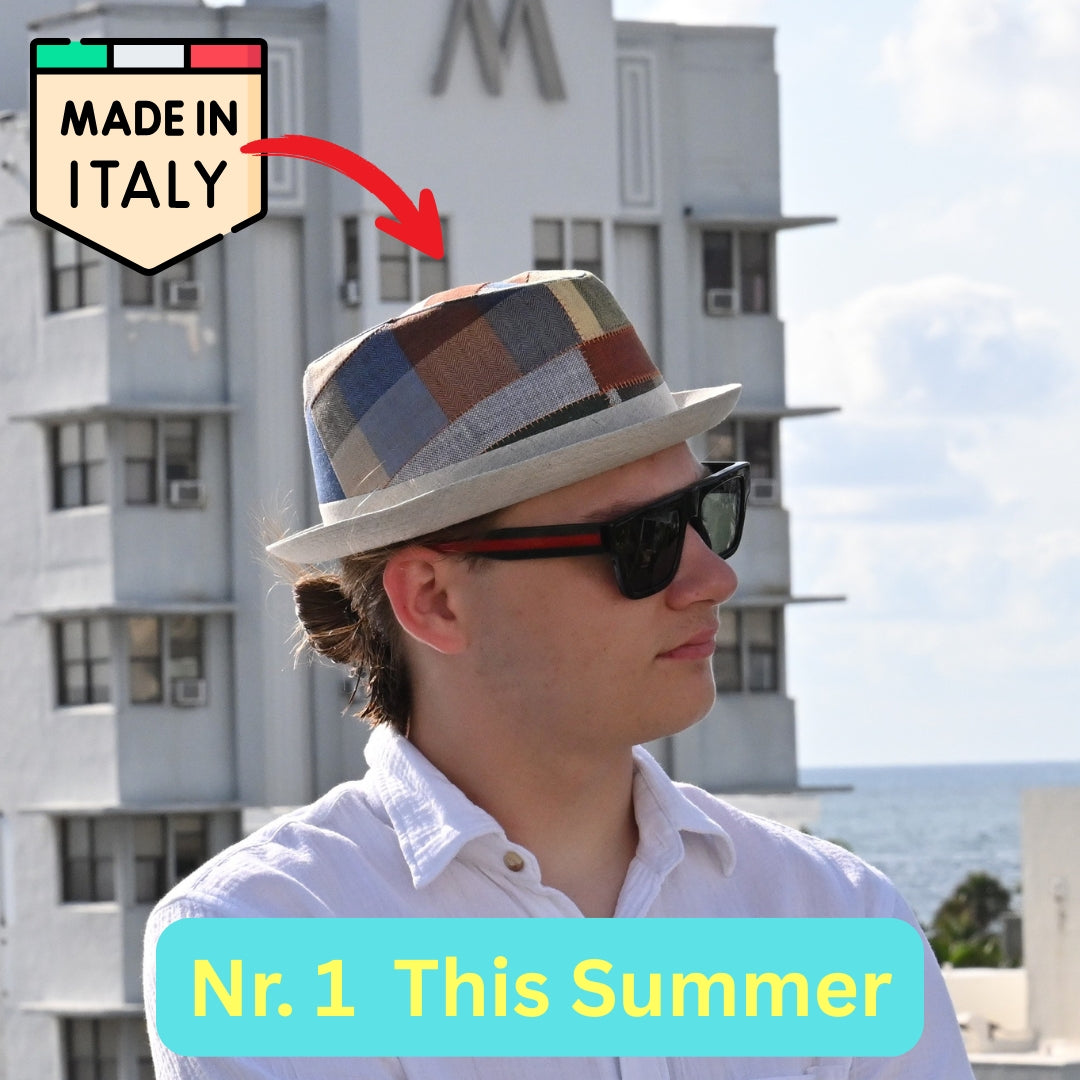 Person wearing a multicolor Italian patchwork pork pie hat and sunglasses with 'Made in Italy' label and text overlay.