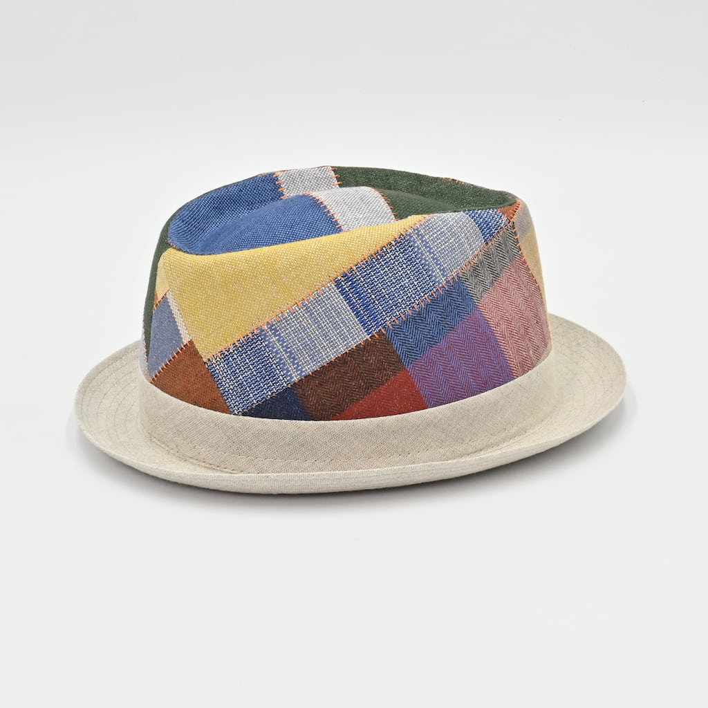 Side view of Multicolored patchwork hat on a light gray background