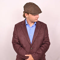 Person in brown leather newsboy hat