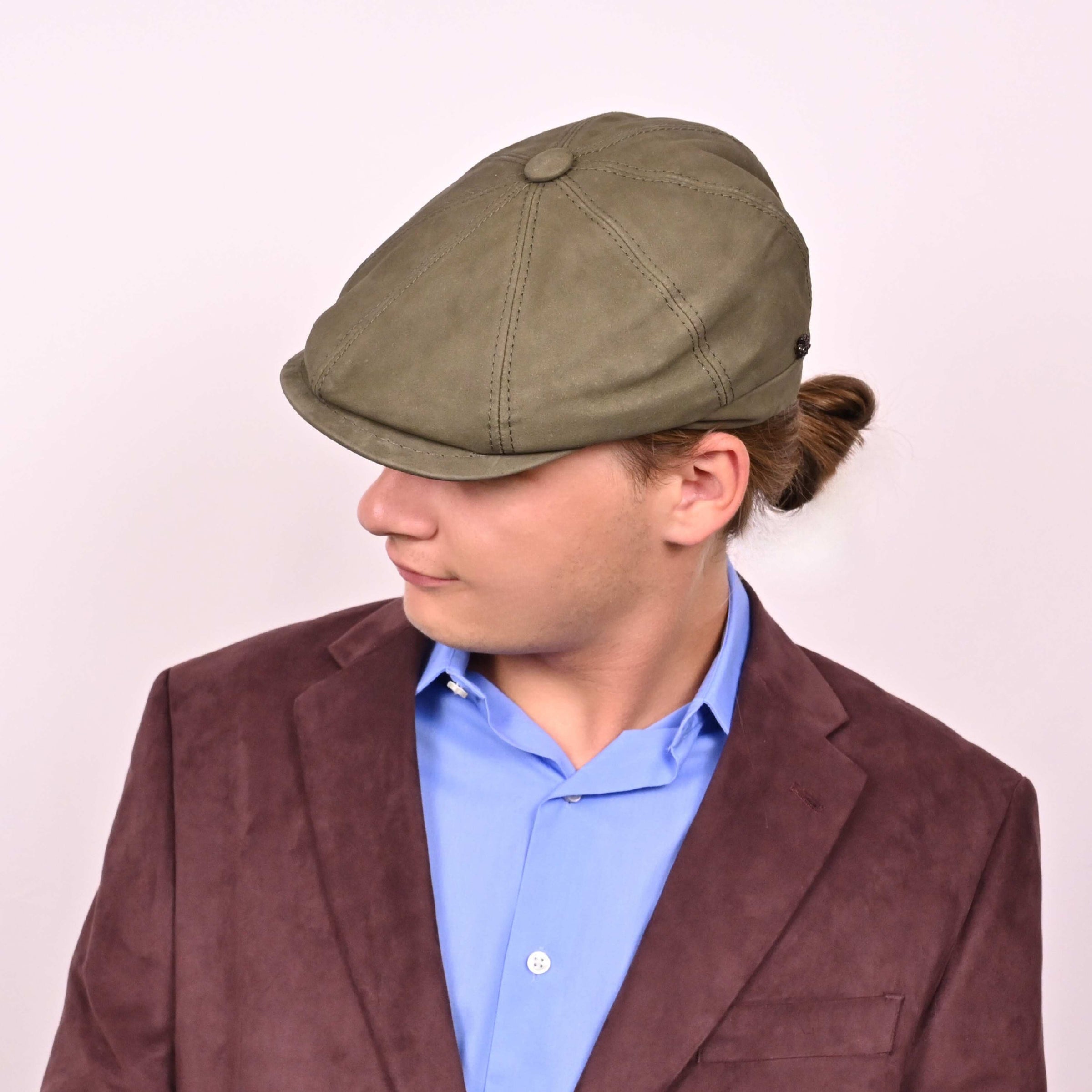 Person in green leather newsboy hat