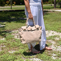 Beige Firenze Soft Leather Handbag front view with landscaping in background