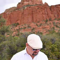 man in ecru Rapallo Linen Flat Cap with sodona red rocks in background