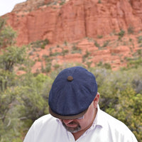 Man in Navy Recco Denim Newsboy Hat with sodona red rocks in background