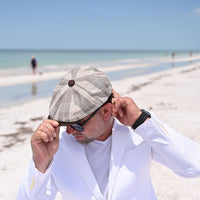 man in Beige Trieste Plaid Newsboy Hat on the beach