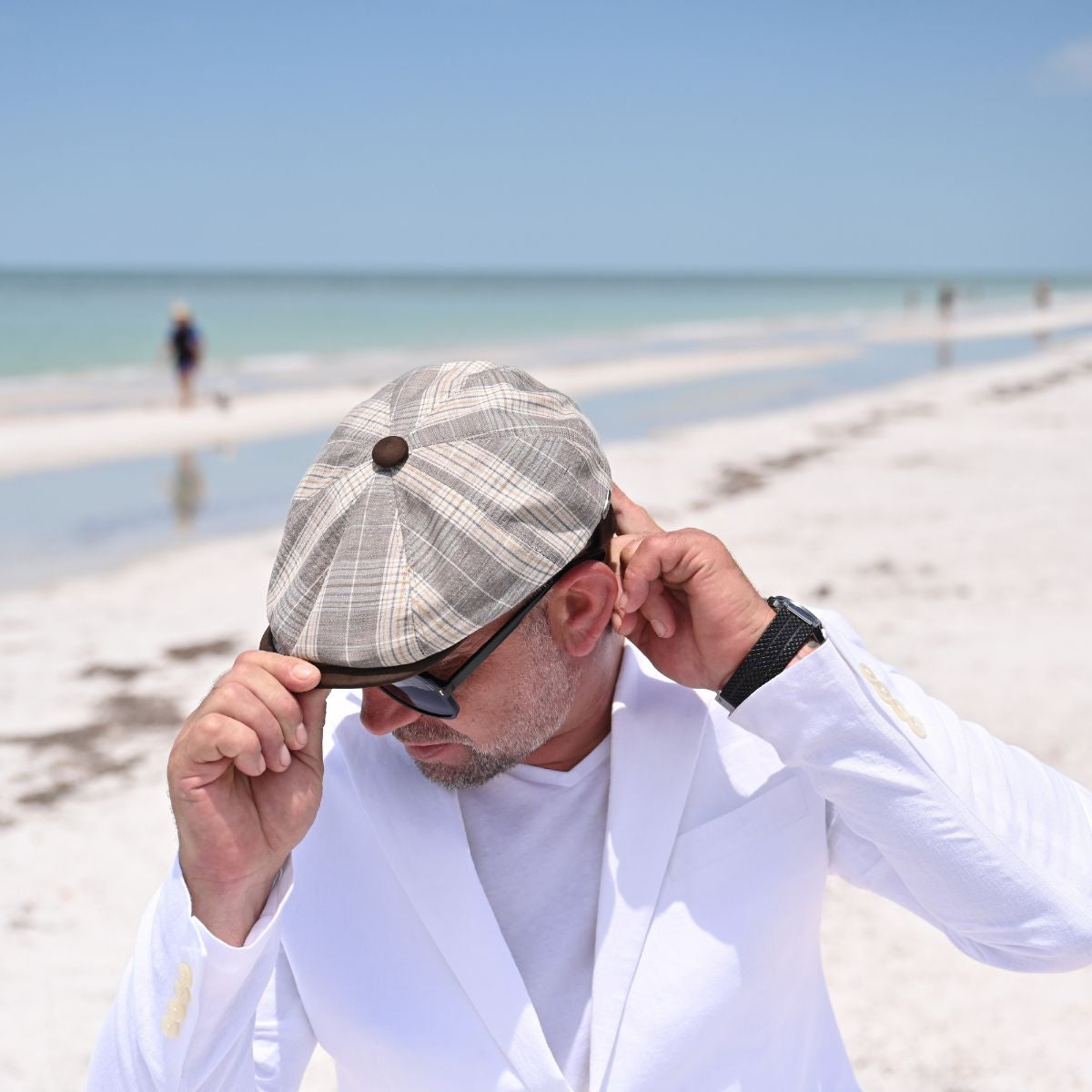 man in Beige Trieste Plaid Newsboy Hat on the beach