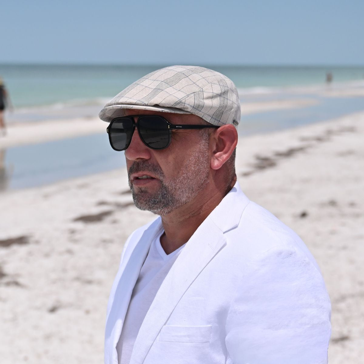 man in Beige Bartolomeo Summer Cap on the beach