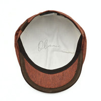 Rustico Linen Newsboy Hat with a button on a white background