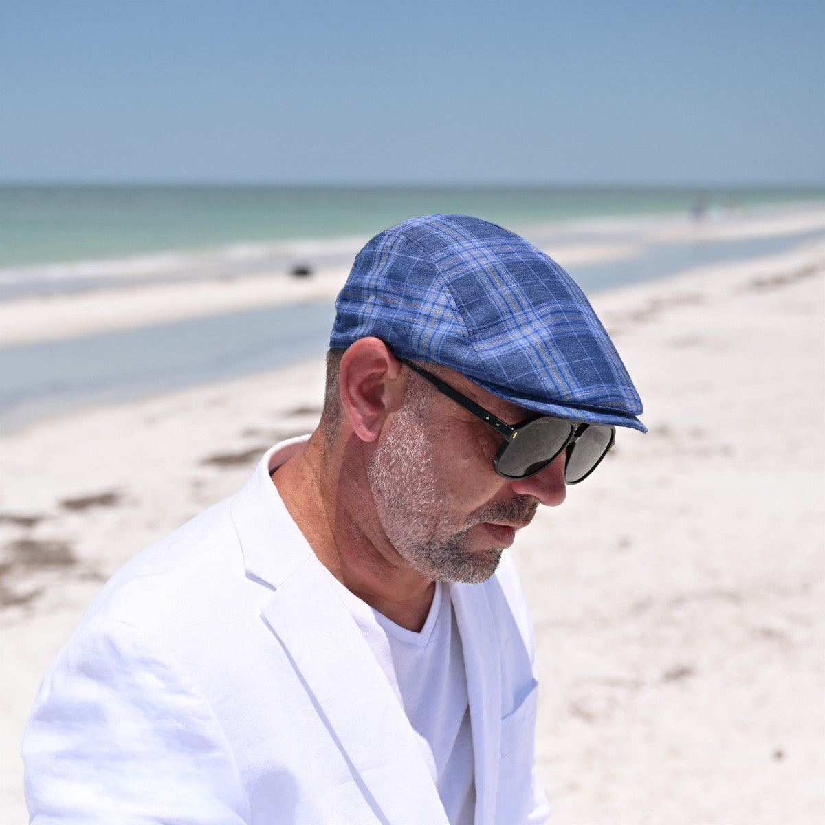 man in blue Portofino Cap on the beach