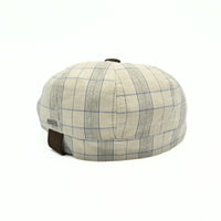 Beige Bartolomeo linen cotton newsboy hat with plaid pattern and leather visor on white background
