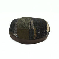 Brown Volterra Newsboy Patchwork Hat on white background. Cappello hat