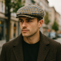 a man wearing multicolor Fantasia Peaky Hat, dressed in a coat, with a city background