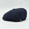 side view of navy Shetland Wool Leather-Trim Newsboy hat handmade in Italy – front view showing leather visor.