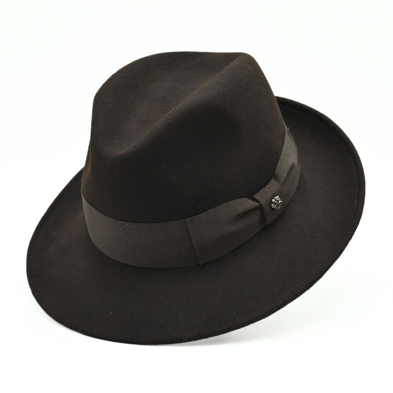 1930's style brown wool hat with metal logo on white background 