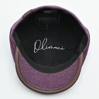 Interior view: “Cotton-lined interior of lavender Shetland wool newsboy hat – handcrafted in Italy.”