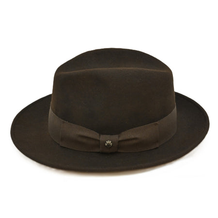 side view of 1930's style brown wool hat with metal logo on white background | Brown