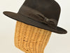 side view of 1930's style brown wool hat with metal logo on mannequin 