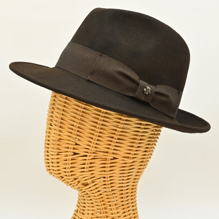 side view of 1930's style brown wool hat with metal logo on mannequin 