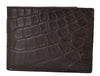 Side view of brown Alligator leather wallet on white background