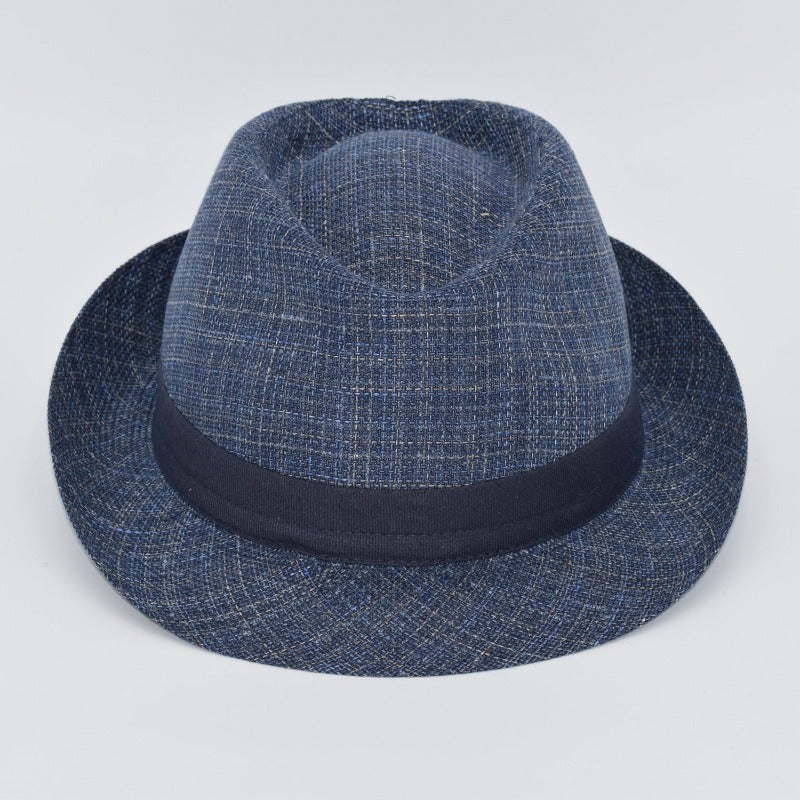 This image features a stylish Alpine fantasy hat made from a light, textured fabric with a blue band around the crown. It has a classic shape, with a slightly curved brim and a subtle logo on the side. The hat's neutral color and sophisticated design make it suitable for a variety of occasions.