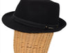 Side view of a black alpine hat displayed on a wicker mannequin head, featuring a black leather band with metallic accents for a sophisticated touch.