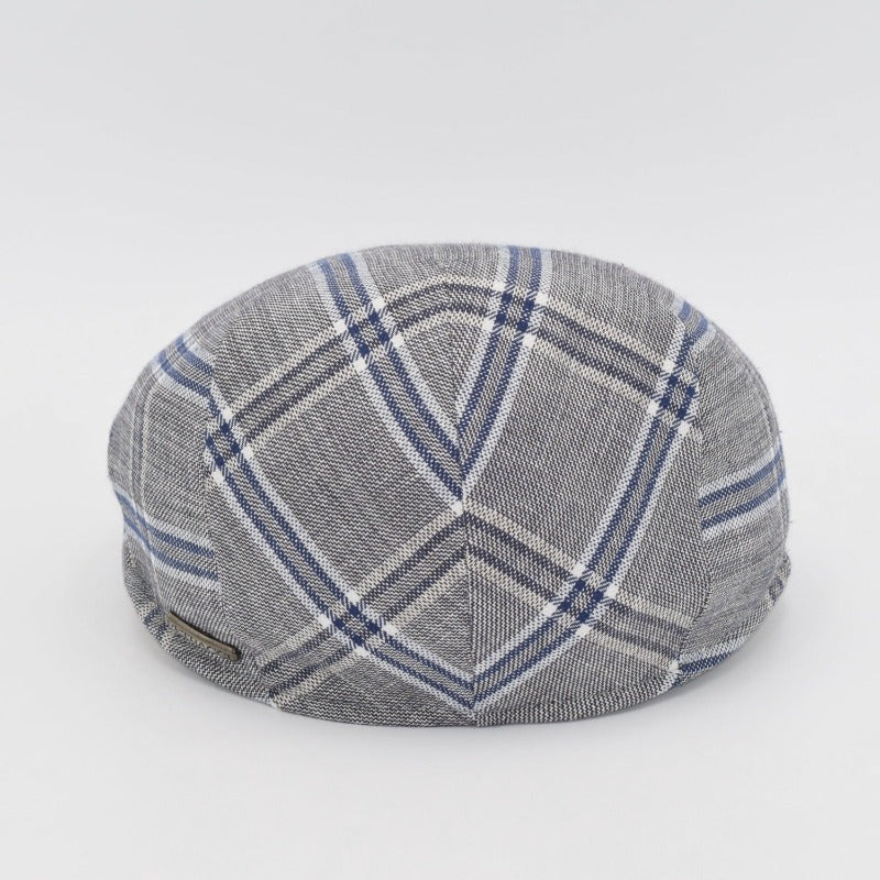 The back view of a gray flat cap with a blue and white plaid pattern, showcasing its symmetrical stitching and subtle metallic logo accent.