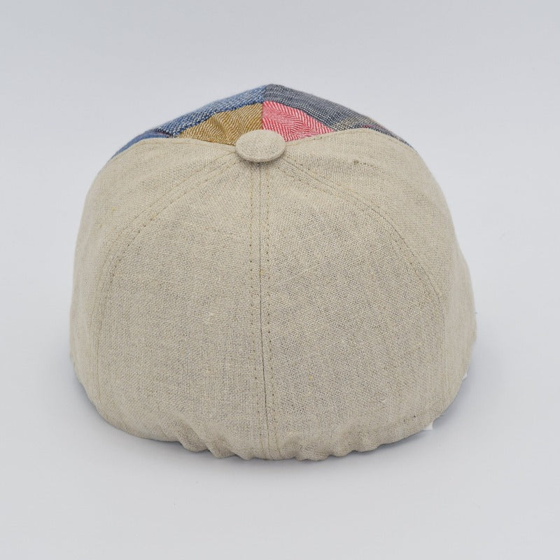 A back view of a beige linen baseball cap featuring subtle stitching details and an elasticized band for a comfortable fit.