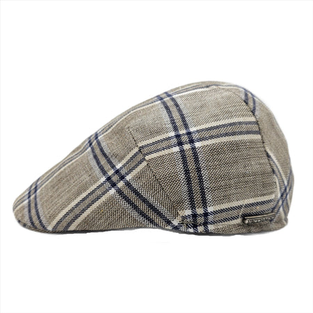 A beige flat cap with a classic blue plaid pattern, showcasing a side profile view and a subtle metallic logo accent on the side.