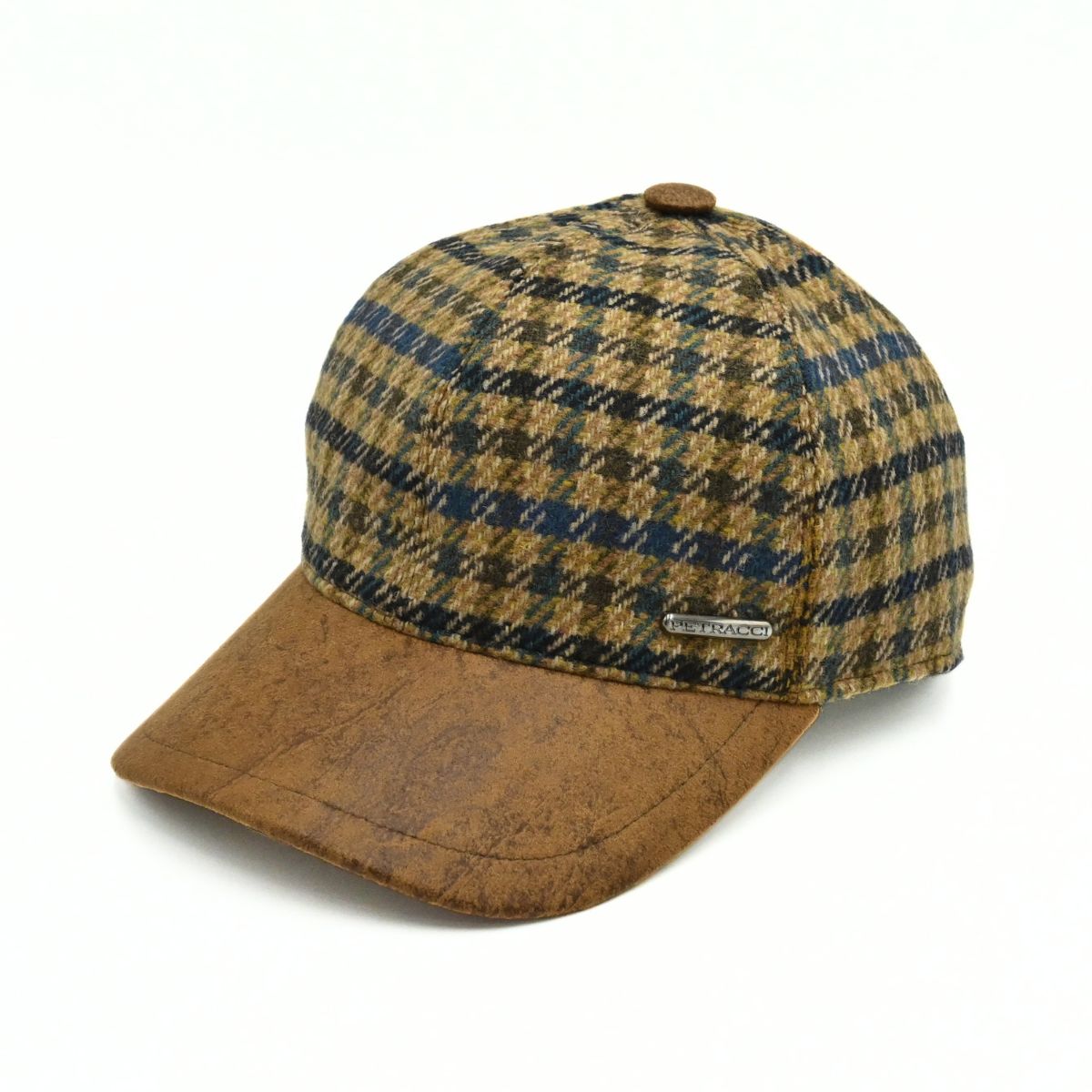 Bolzano Heritage Wool Baseball Cap featuring a brown and navy blue plaid pattern on the crown, with a textured brown visor and a small metal brand tag on the side, set against a plain white background.