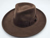 A classic brown felt fedora with a wide brim and a matching ribbon band featuring a subtle bow detail, displayed on a plain background.