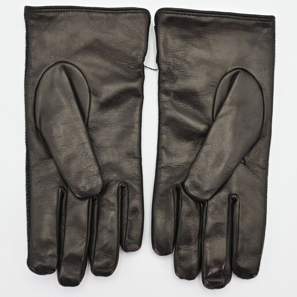 Back view of a pair of black gloves made from smooth leather, showcasing a sleek and minimalist design with a soft finish.