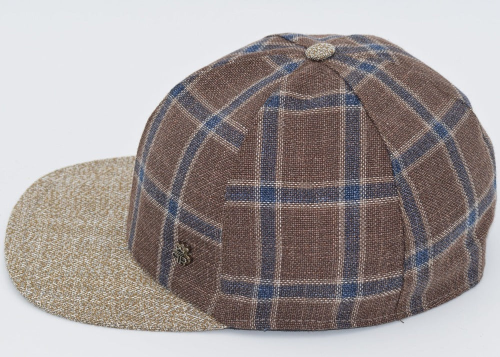 Brown plaid baseball cap with blue and beige checkered patterns, a textured beige brim, and a matching fabric button on top, featuring a small metallic logo detail on the side.