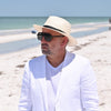 Cappello Fashion Ivory Panama Hat Indiana Style With Leather Strap on model with ocean in background