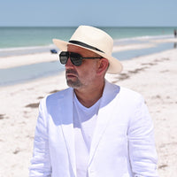 Cappello Fashion Ivory Panama Hat Indiana Style With Leather Strap on model with ocean in background