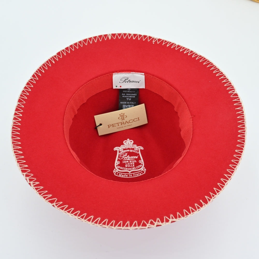 A bright red felt fedora hat with white decorative stitching along the brim and crown, featuring a red ribbon band with a small metallic button detail