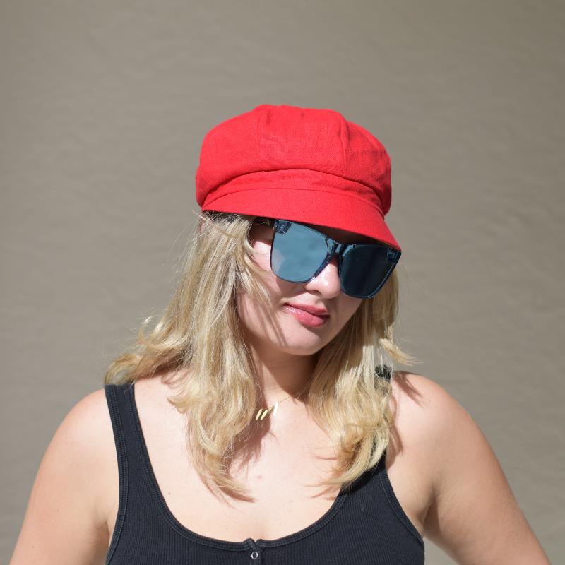 Women's Reversible Beanie, available in vibrant red on one side or a colorful abstract pattern on the other, featuring a soft, rounded design with a short brim.