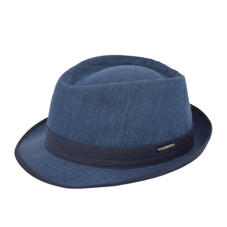 Blue denim alpine hat with a structured crown, navy ribbon band, and a small metallic logo detail, blending casual and elegant style