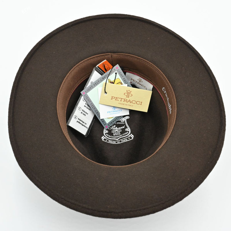 Interior tags and leather sweatband of brown Indiana Jones wool fedora
