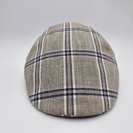 A beige flat cap with a blue plaid pattern, viewed from the front, highlighting its classic and timeless design.